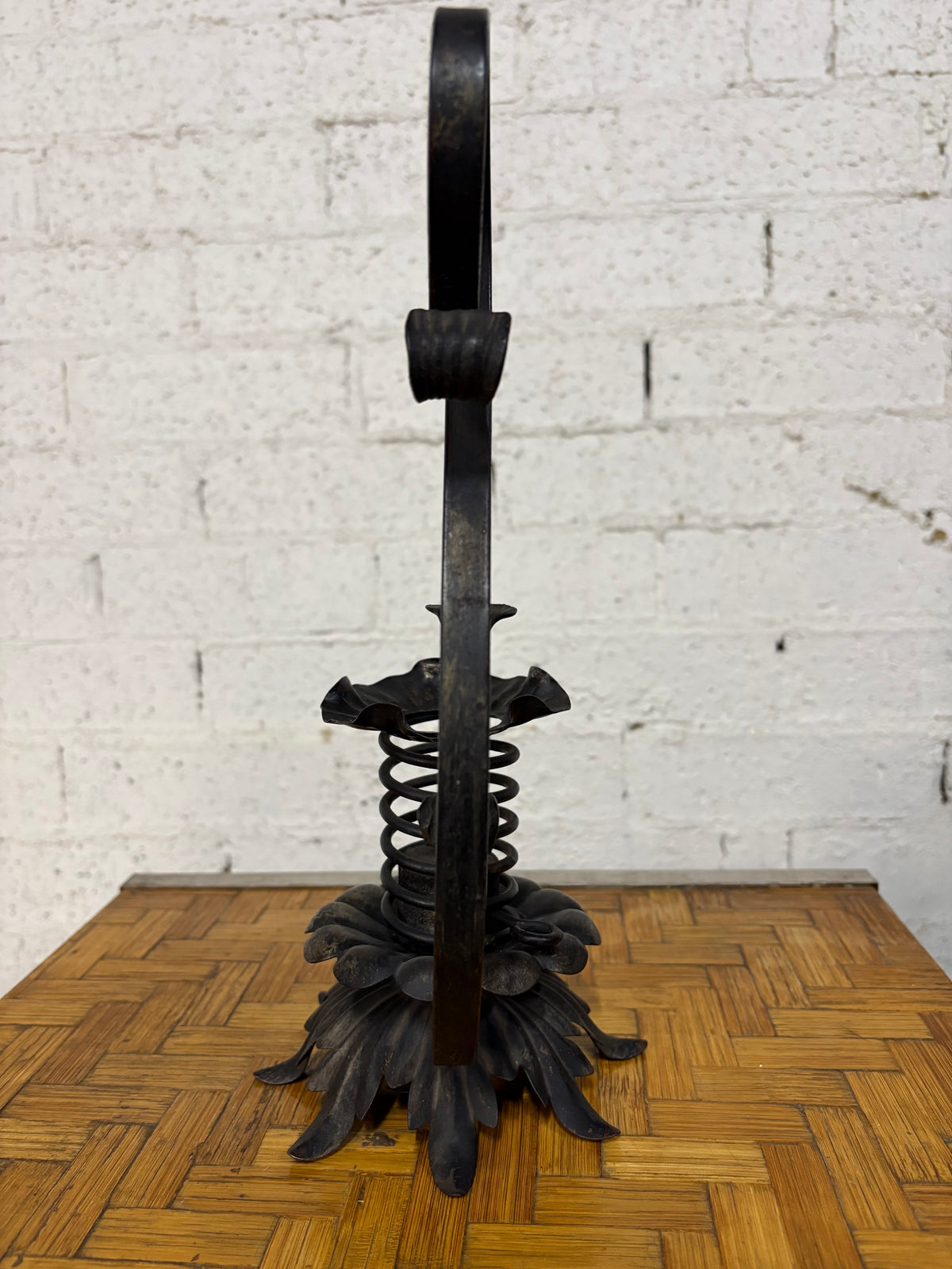 Wrought-Iron Brutalist Spring Candlestick with Floral Base and Scroll Handle, c.1920s