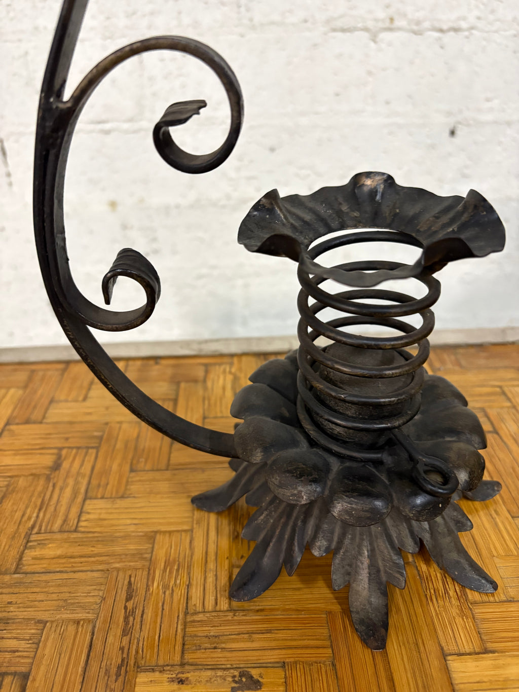 Wrought-Iron Brutalist Spring Candlestick with Floral Base and Scroll Handle, c.1920s