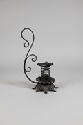 Wrought-Iron Brutalist Spring Candlestick with Floral Base and Scroll Handle, c.1920s