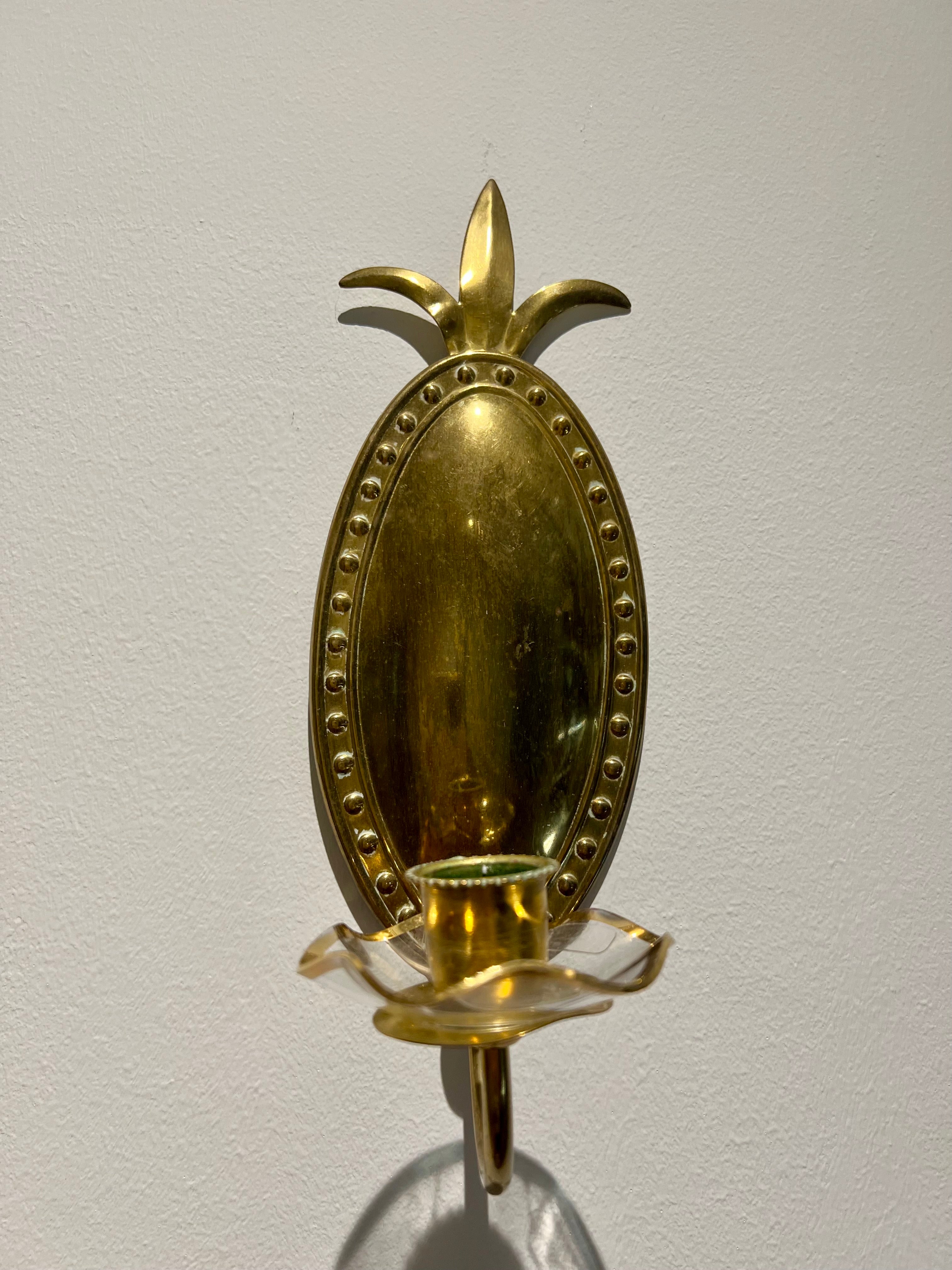 Embossed brass wall sconce