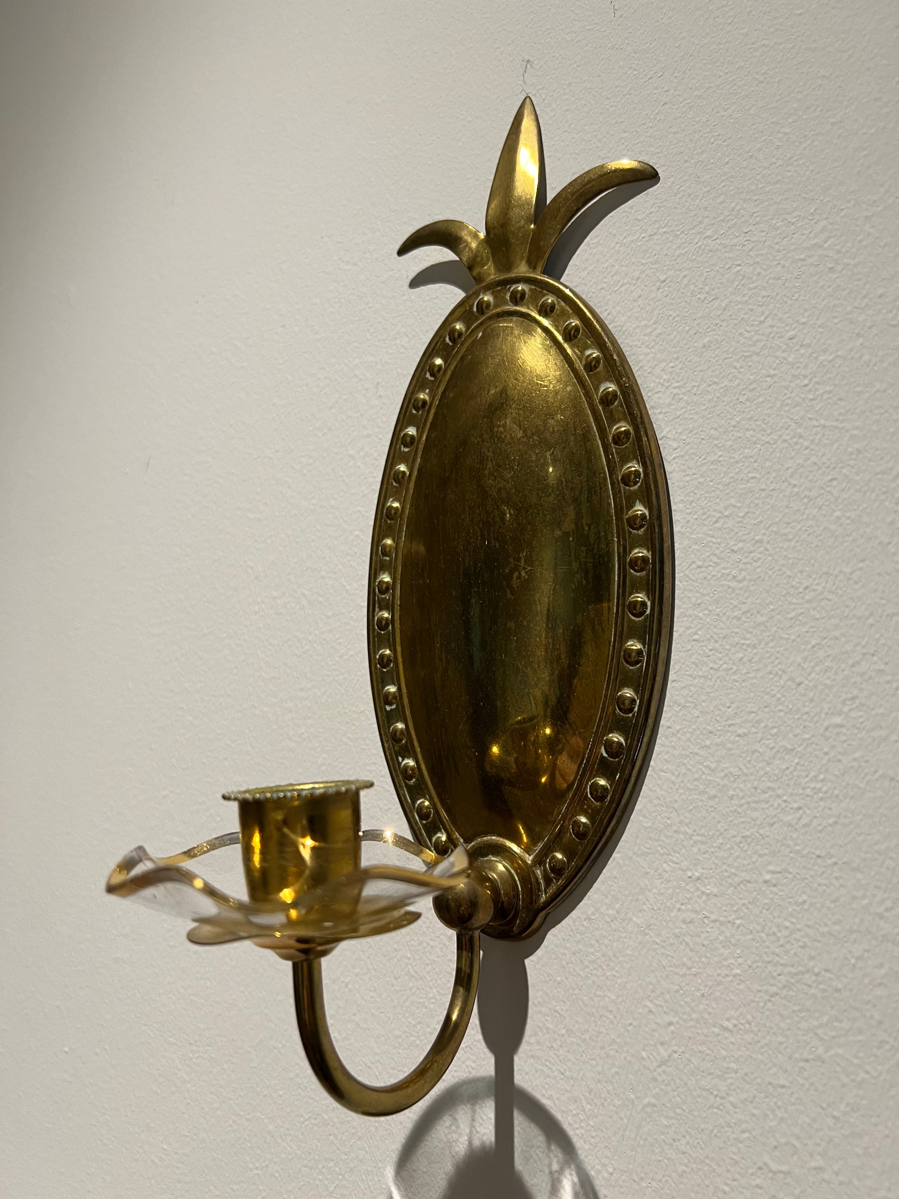 Embossed brass wall sconce