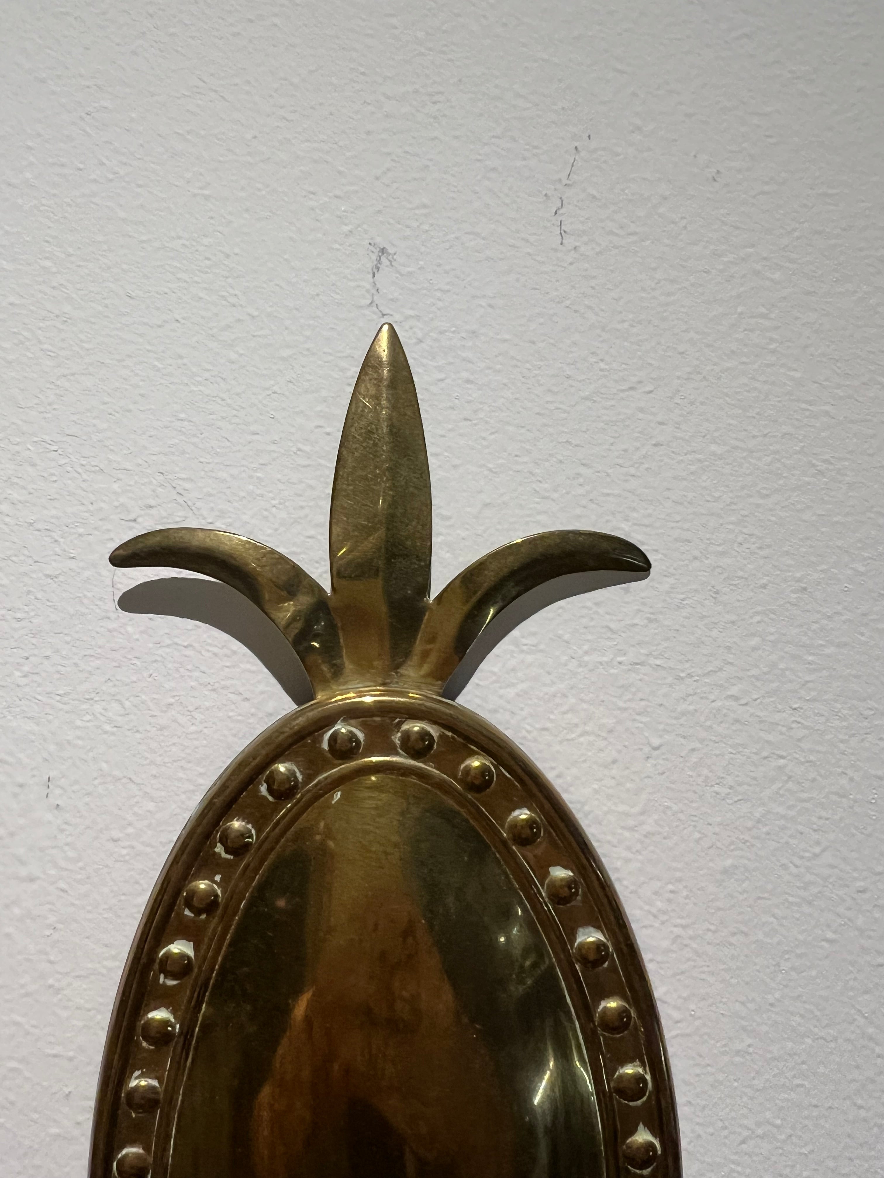 Embossed brass wall sconce
